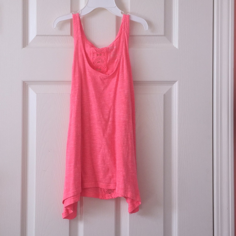 Pink tank top with partial cut out design on back.